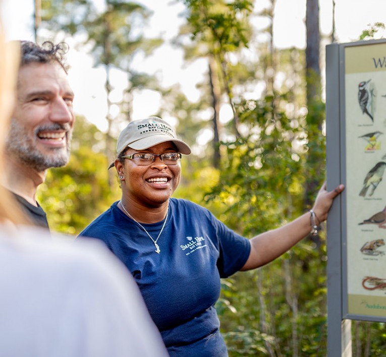 Tour guide teaching group about birdwatching