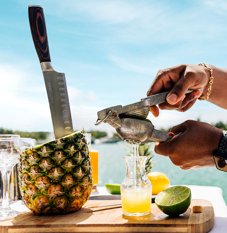 a person making a pineapple drink