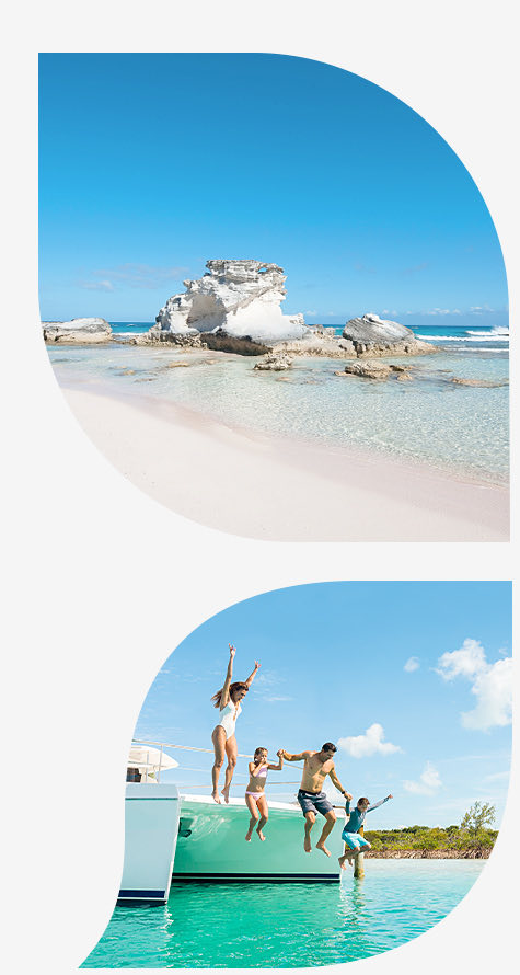 white sand beach with clear water and rocks bottom image family jumping off sailboat