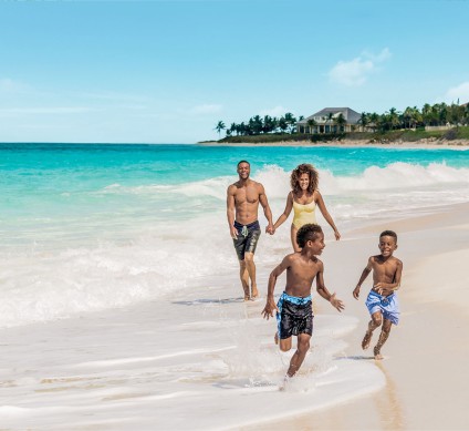 a group of people running on a beach