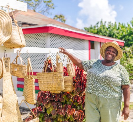 a person carrying baskets of fruit