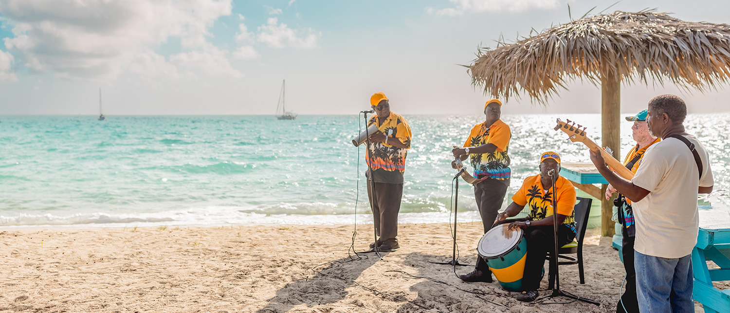 a group of people playing instruments on the beach 