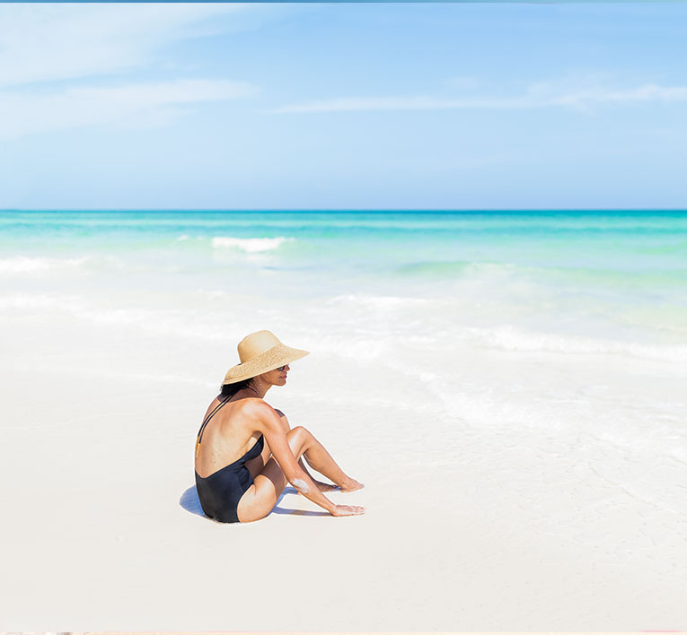 a woman sitting on the beach 