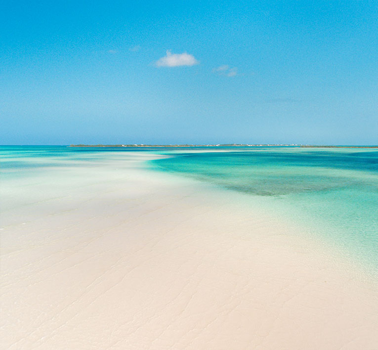 a sandy beach with blue water