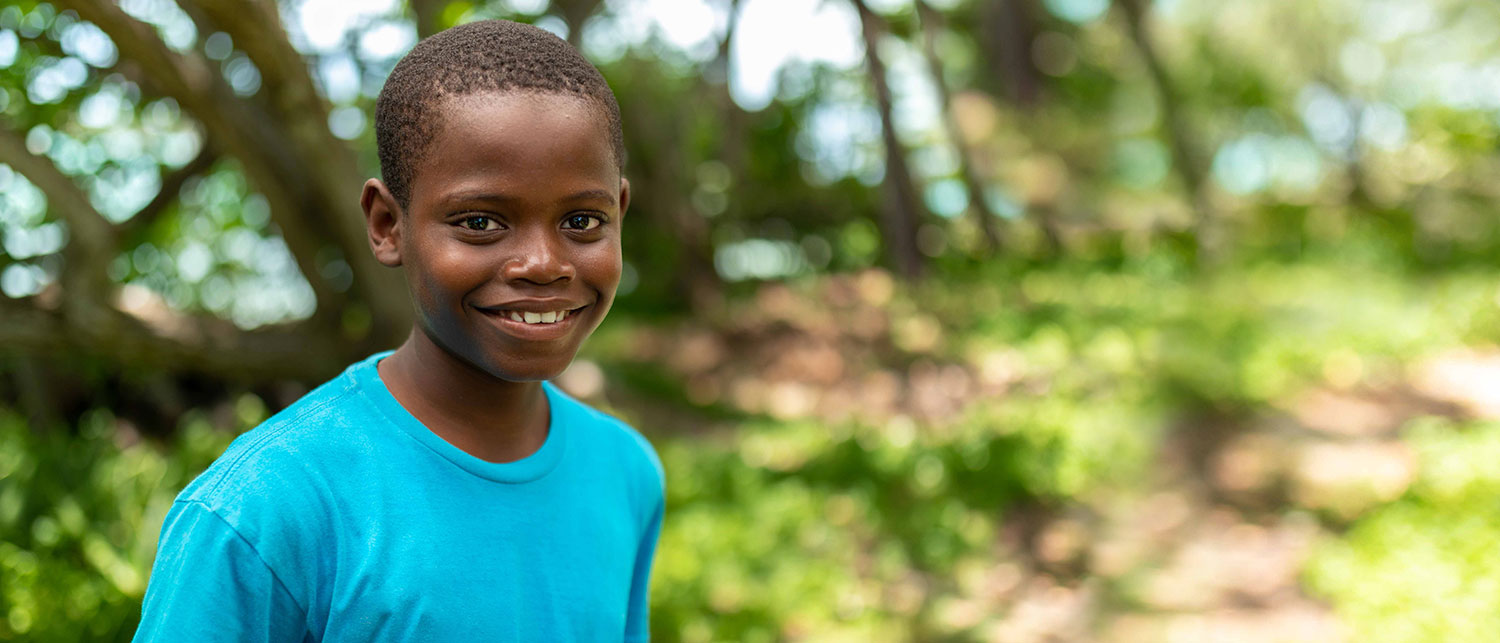 a boy smiling outside