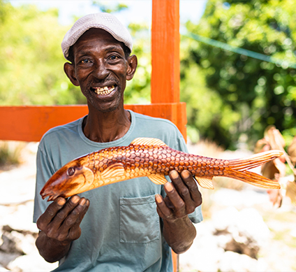 a man holding a wood fish