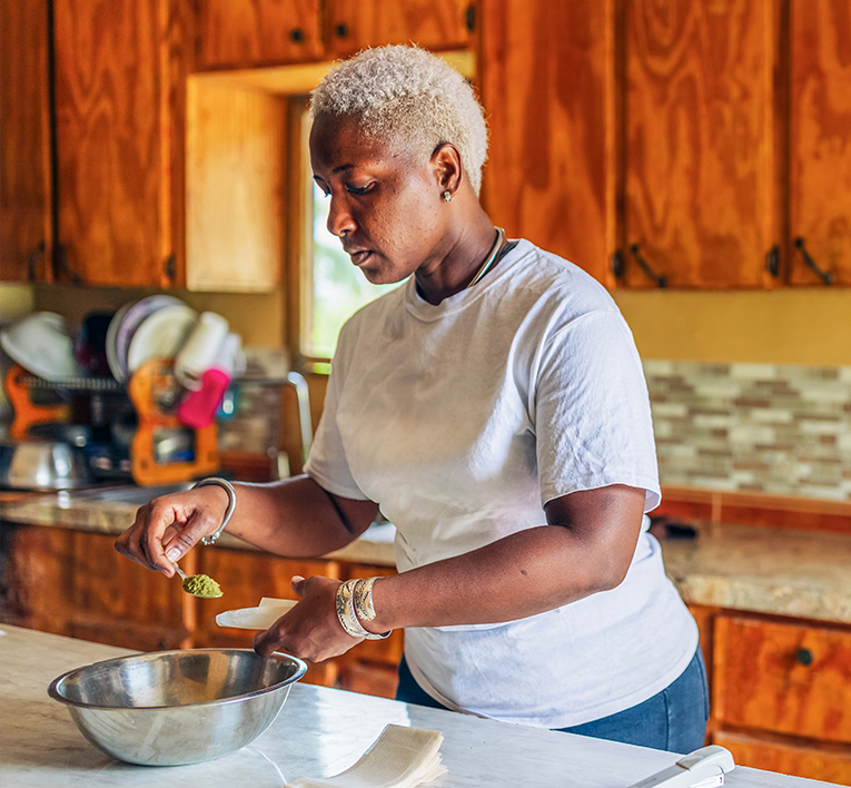 a woman cooking in a kitchen