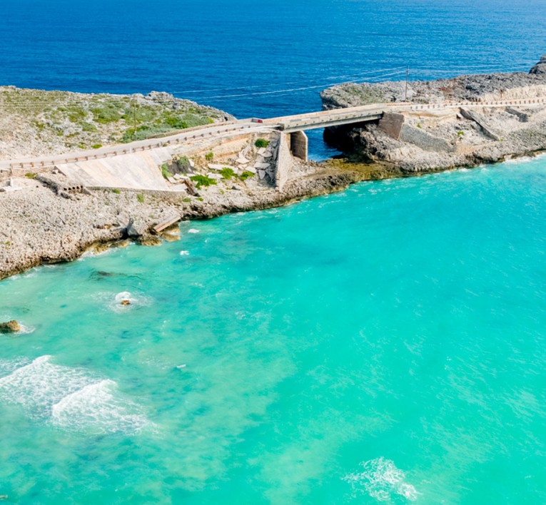 view of a bridge with rocky landscape on both sides